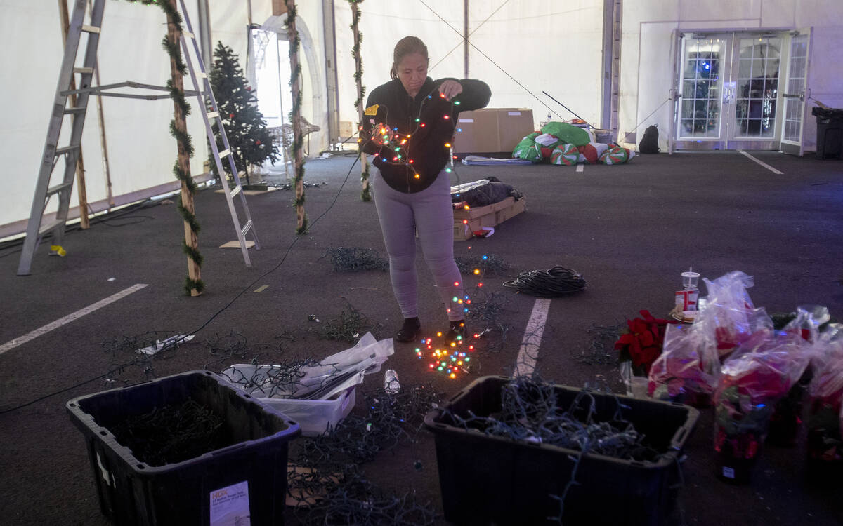 Kristy Reinhardt checks different lights during setup of Christmas on the Strip, Friday, Nov. 2 ...