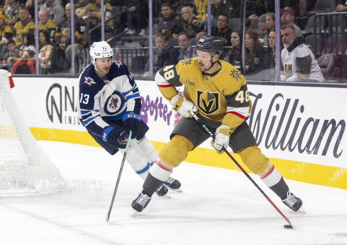 Golden Knights center Tomas Hertl (48) moves the puck around Winnipeg Jets center Gabriel Vilar ...