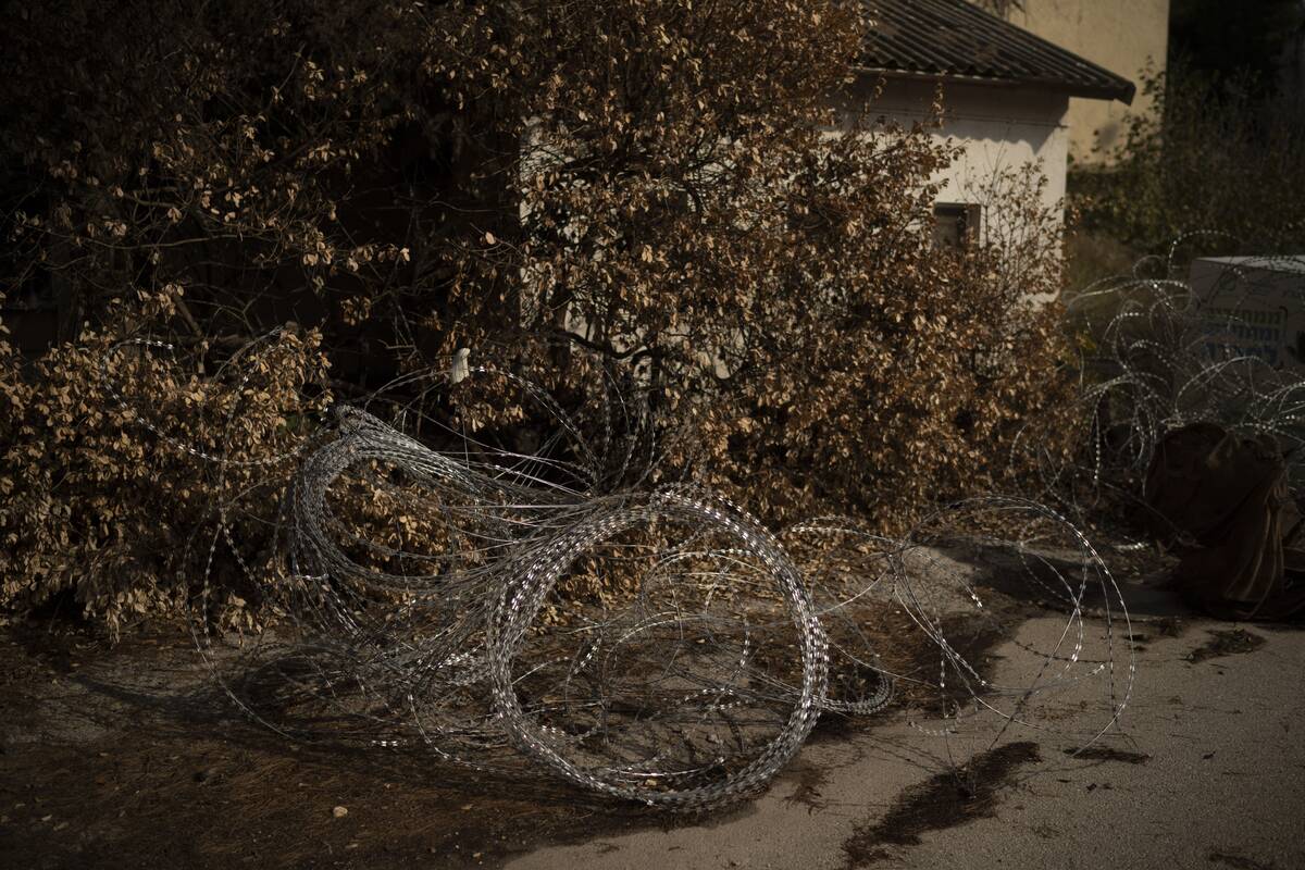 Barbed wires are set on an area in front a house of the Kibbutz Manara, which is located near t ...