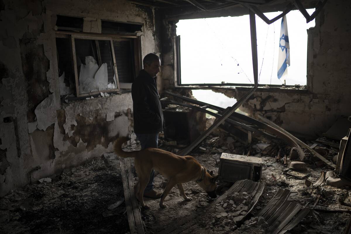 Naor Shamia, manager of the kibbutz emergency unit, stands at room of a house that was hit by a ...