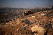 Backdropped by a Lebanese village an Israeli army position sits near the Israeli-Lebanese borde ...