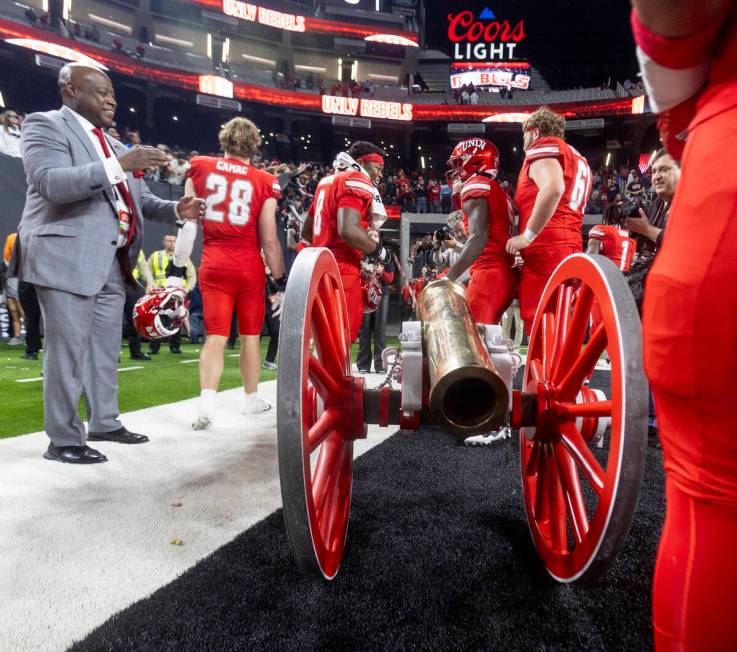 UNLV players wheel the Fremont Cannon to the locker room after winning the NCAA college footbal ...