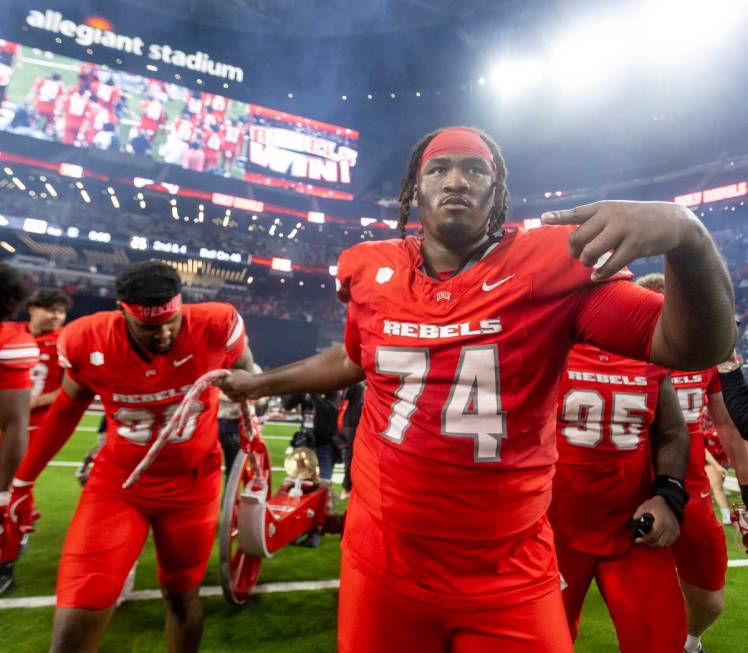 UNLV offensive lineman Jalen St. John (74) wheels the Fremont Cannon to center field after winn ...