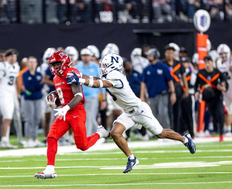 UNLV running back Jai'Den Thomas (9) attempts to outrun UNR cornerback Michael Coats Jr. (3) du ...