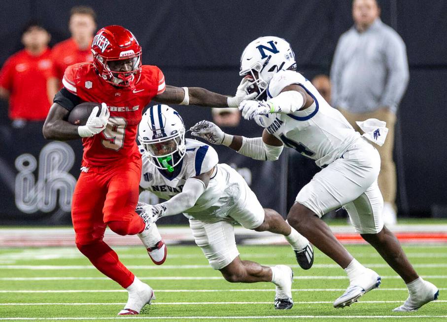 UNLV running back Jai'Den Thomas (9) avoids numerous tacklers during the NCAA college football ...