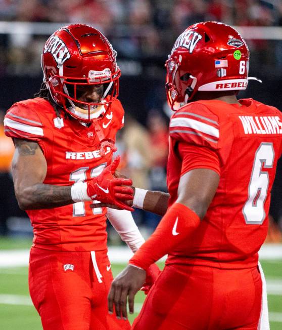 UNLV wide receiver Ricky White III (11) celebrates a touchdown with quarterback Hajj-Malik Will ...