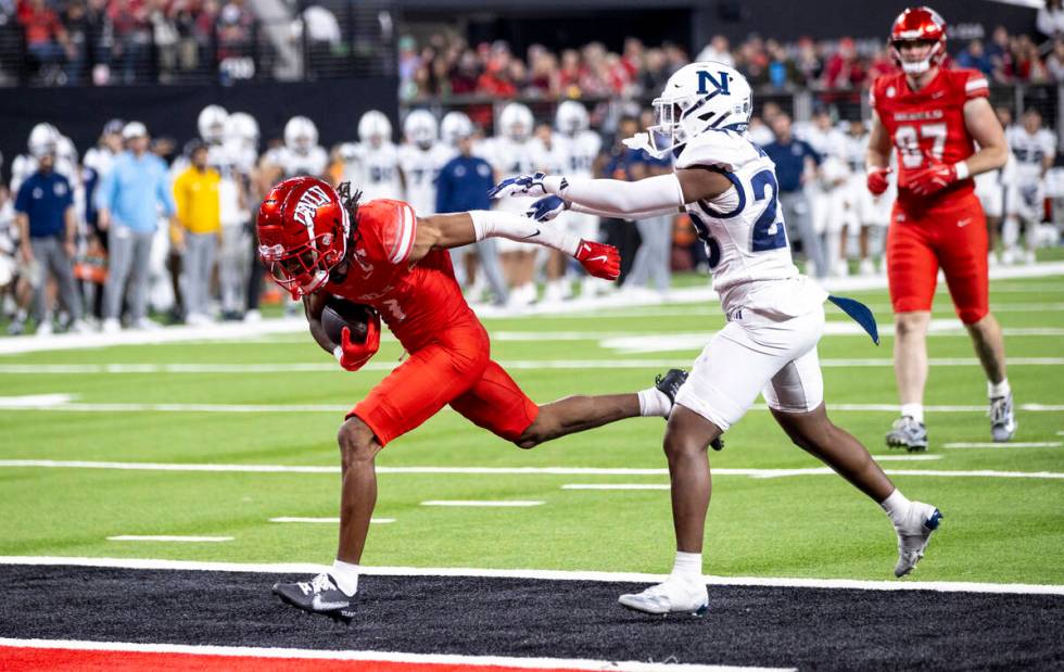 UNLV wide receiver Ricky White III, left, runs into the end zone for a touchdown during the NCA ...