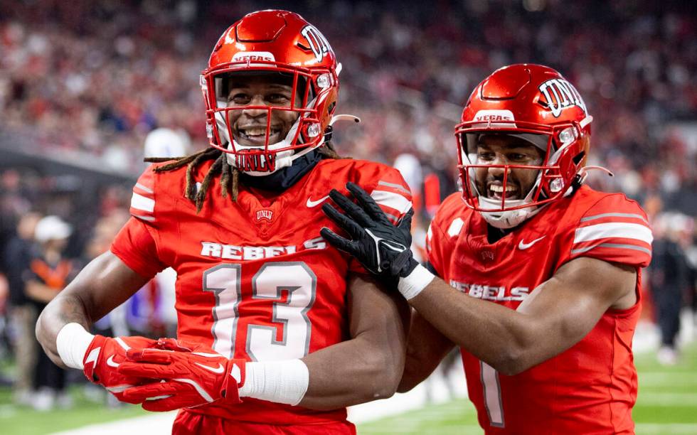 UNLV defensive back Jarvis Ware (13) and defensive back Jalen Catalon (1) celebrate a play duri ...