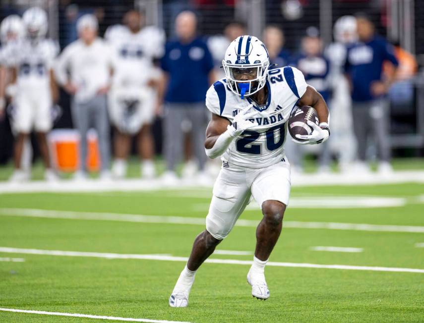 UNR running back Caleb Ramseur (20) runs with the ball during the NCAA college football game ag ...