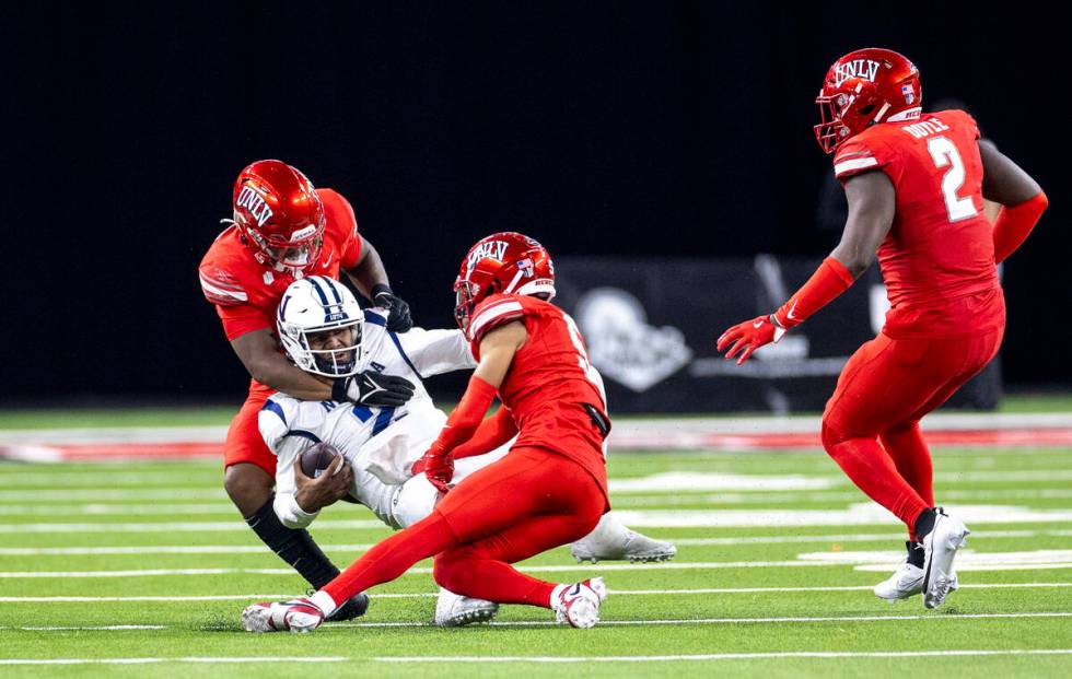 UNR quarterback Brendon Lewis (2) is tackled during the NCAA college football game against UNLV ...