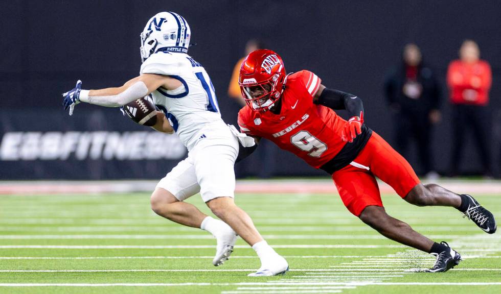 UNLV defensive back Jett Elad (9) attempts to tackle UNR wide receiver Marcus Bellon, left, dur ...