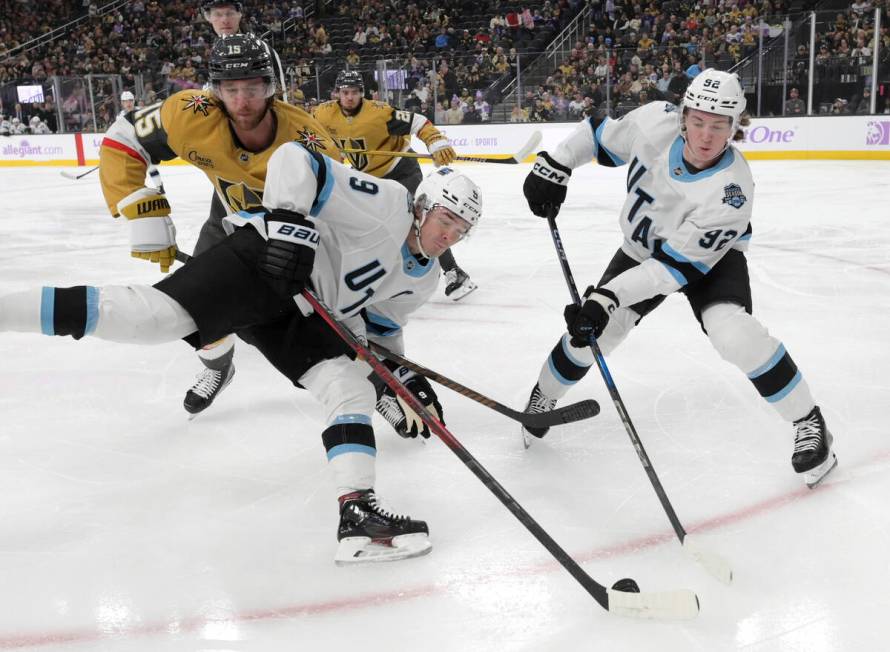 Utah Hockey Club centers Clayton Keller (9) and Logan Cooley (92) keep a face-off puck away fro ...