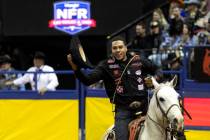 Shad Mayfield, of Clovis, N.M., takes a victory lap after winning the tie-down roping competiti ...