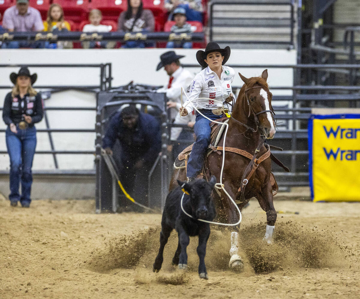 Shelby Boisjoli-Meged of Stephenville, Texas, ropes a calf during the NFR breakaway roping chal ...