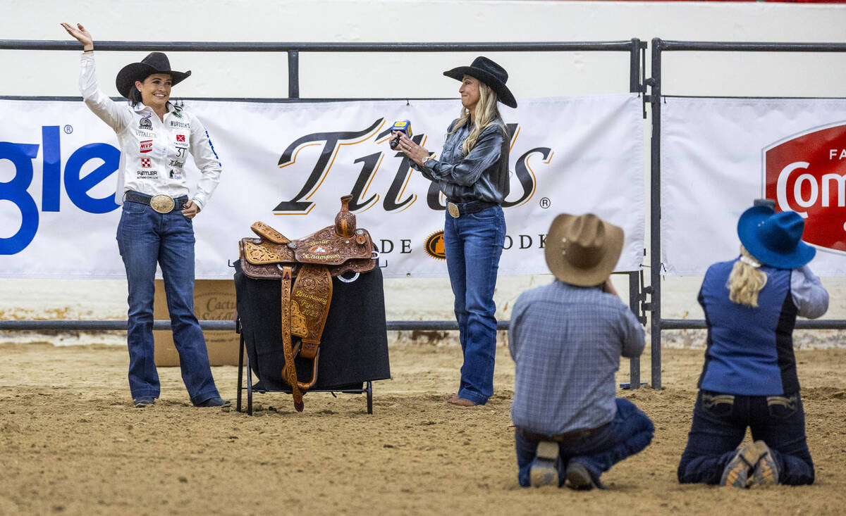 Shelby Boisjoli-Meged of Stephenville, Texas, waves to the crowd while receiving her saddle as ...