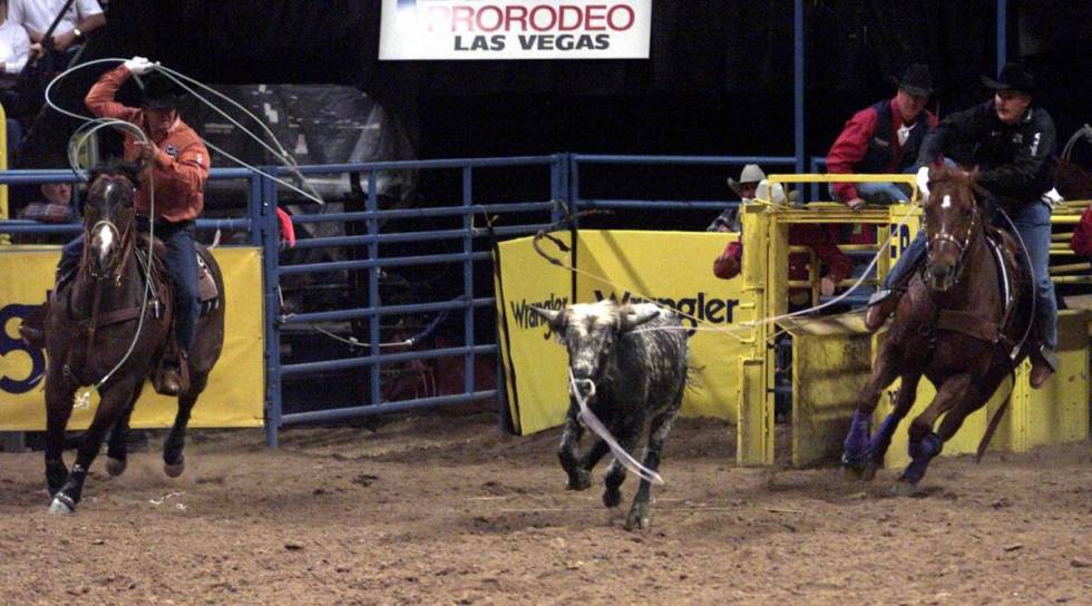 Heeler Rich Skelton and header Speed Williams work their steer during ninth go-round team ropin ...