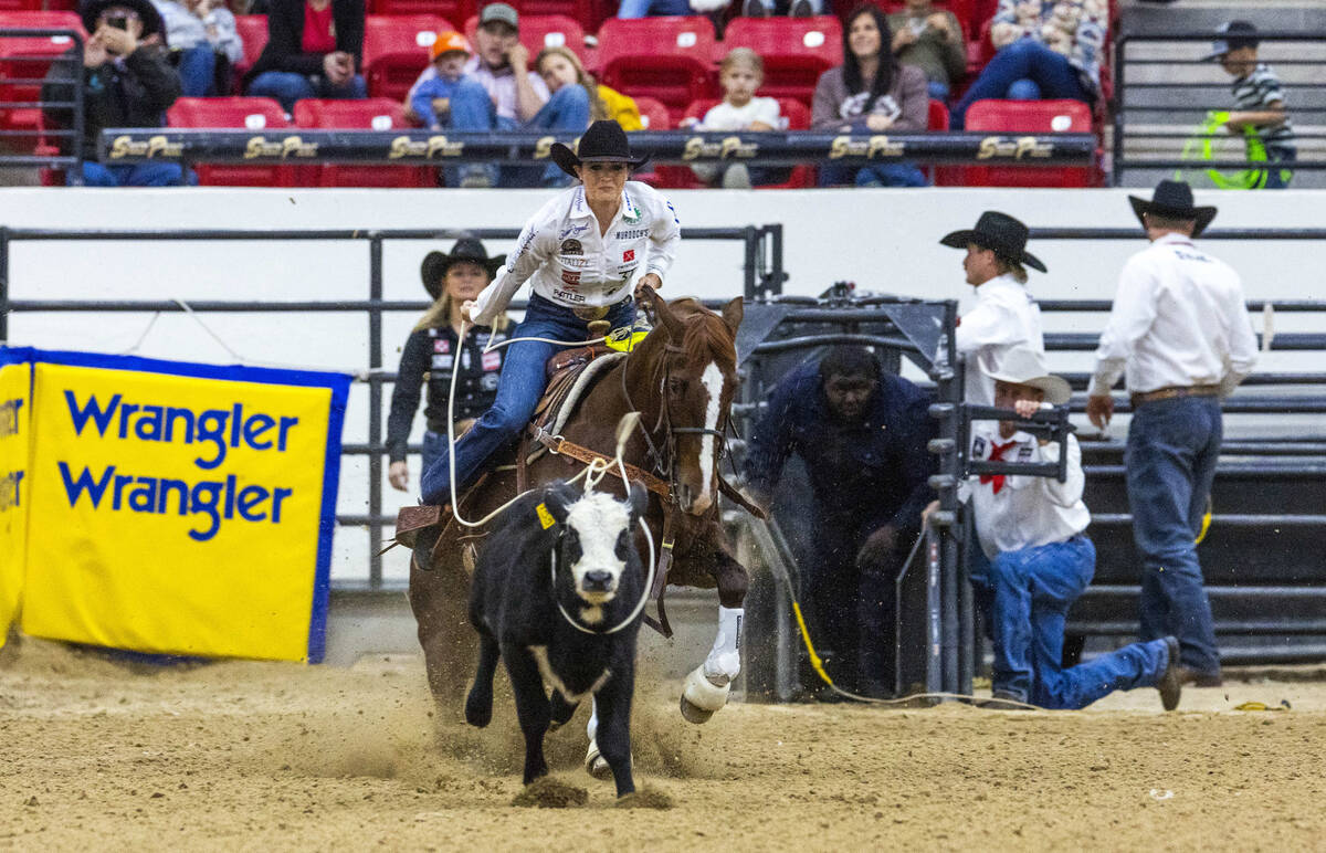 Shelby Boisjoli-Meged of Stephenville, Texas, ropes a calf during the NFR breakaway roping chal ...