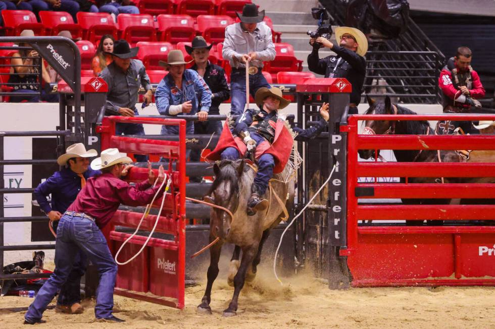 Leighton Berry breaks out of the bucking chute during The Run For A Million bareback riding com ...