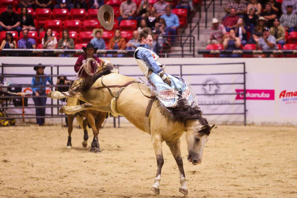 Keenan Hayes loses his hat during his ride in The Run For A Million bareback riding competition ...