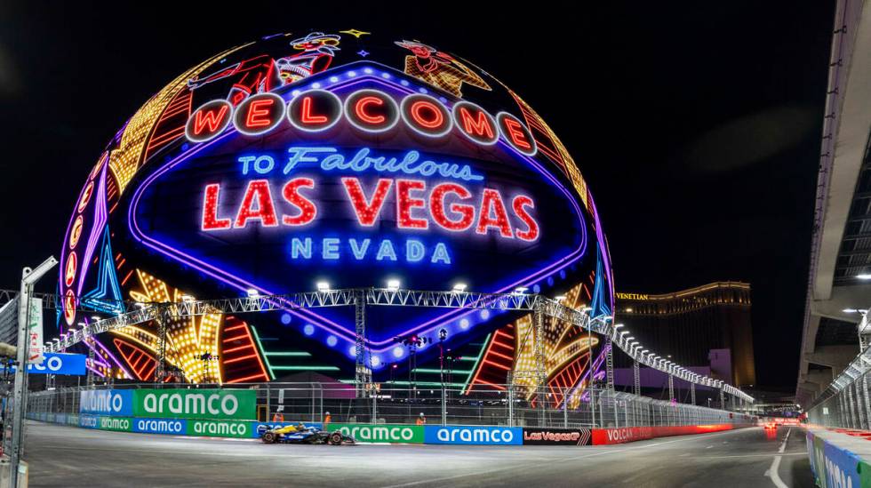 A race car navigates around the Sphere during the qualifying round for the Formula 1 Las Vegas ...