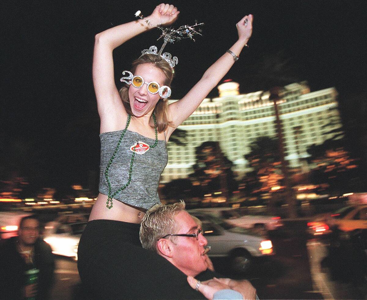 Jesse Evans celebrates on the back of Jared McCullough on New Years Eve in front of Bally's. (L ...