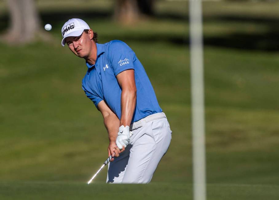 Maverick McNealy chips a shot onto the green at hole #18 during the opening round of the Shrine ...