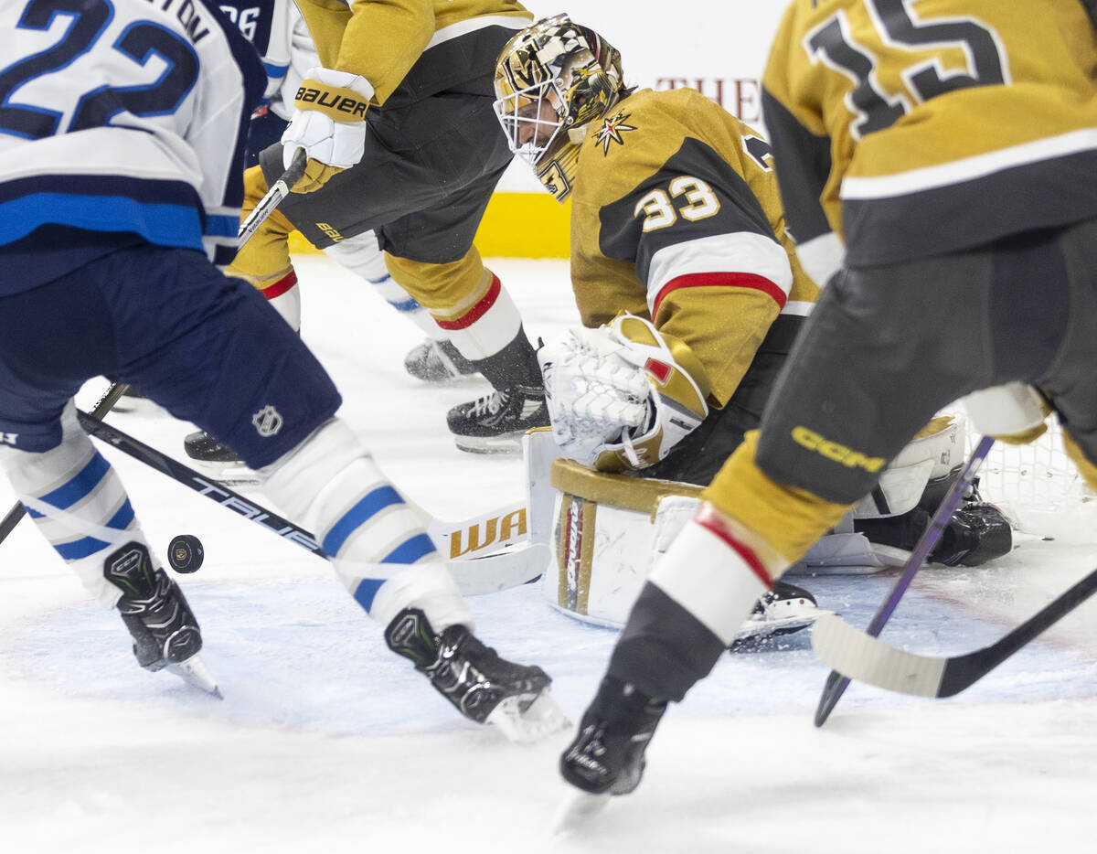 Golden Knights goaltender Adin Hill (33) watches the puck during the NHL hockey game against th ...