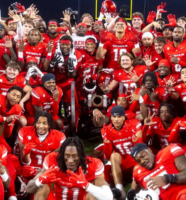 UNLV poses with the Fremont Cannon after winning the NCAA college football game against UNR 38- ...