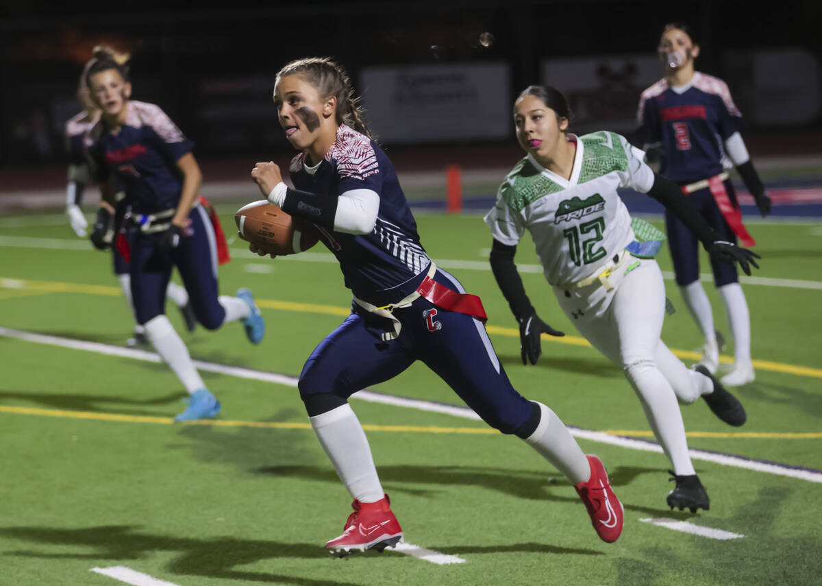 Coronado's Bailey Goldberg (1) runs the ball under pressure from Green Valley's Destany Jauregu ...