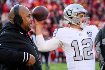 Las Vegas Raiders head coach Antonio Pierce, left, watches Raiders quarterback Aidan O'Connell ...