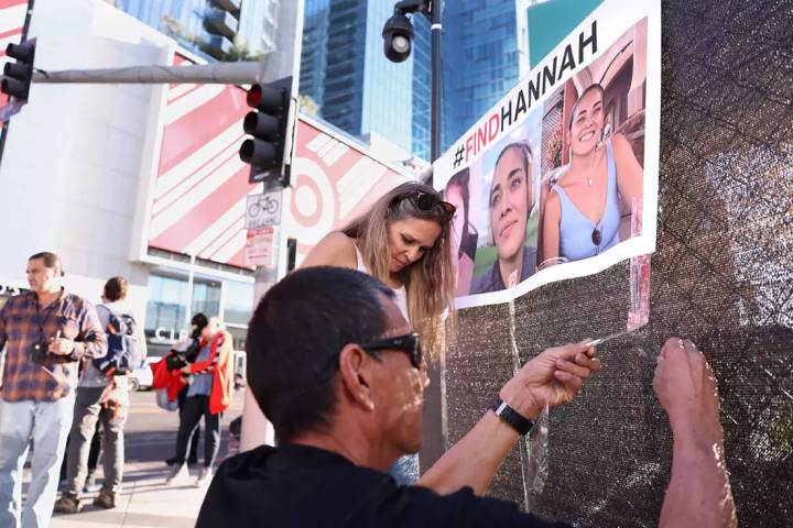 Volunteers put up flyers of missing Hawaii woman Hannah Kobayashi outside Crypto.com Arena in L ...