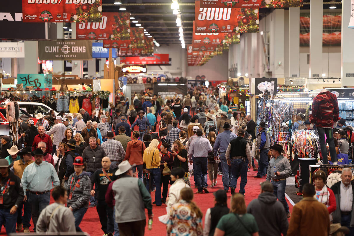 Shoppers browse booths during Cowboy Christmas at the Las Vegas Convention Center Thursday, Dec ...