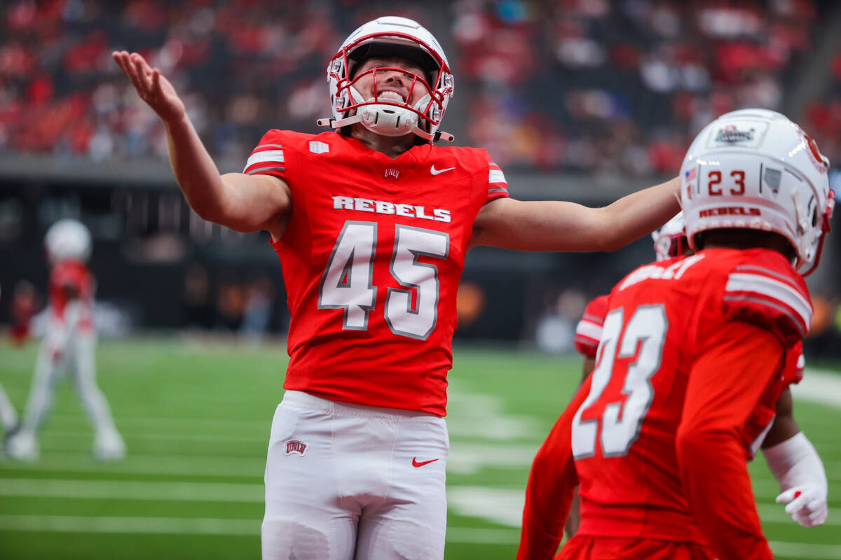 UNLV place kicker Caden Chittenden (45) pumps up the crowd during an NCAA football game between ...