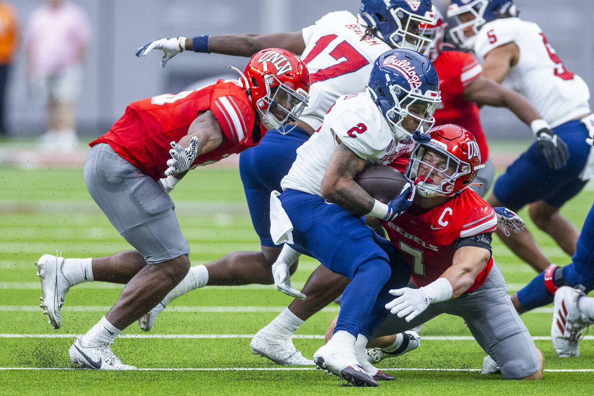 Fresno State running back Malik Sherrod (2) is stopped for a loss by UNLV linebacker Jackson Wo ...