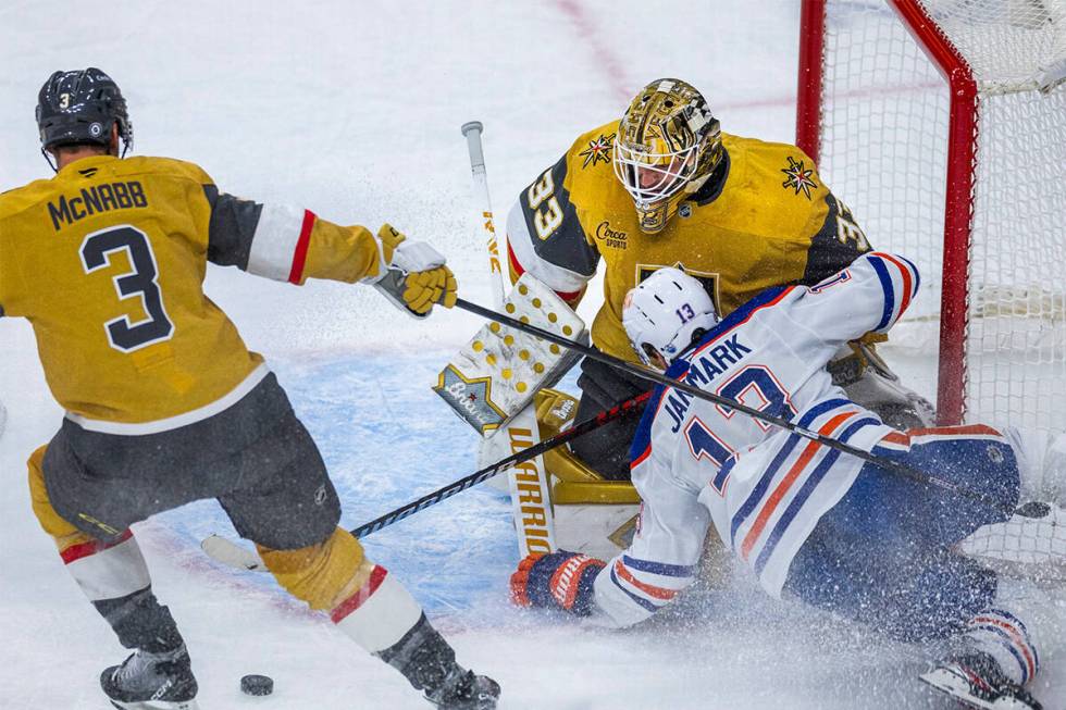 Golden Knights goaltender Adin Hill (33) deflects away a shot as Edmonton Oilers center Mattias ...