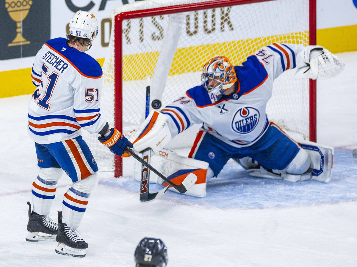 Edmonton Oilers goaltender Stuart Skinner (74) has a shot hit the post then off his arm as team ...