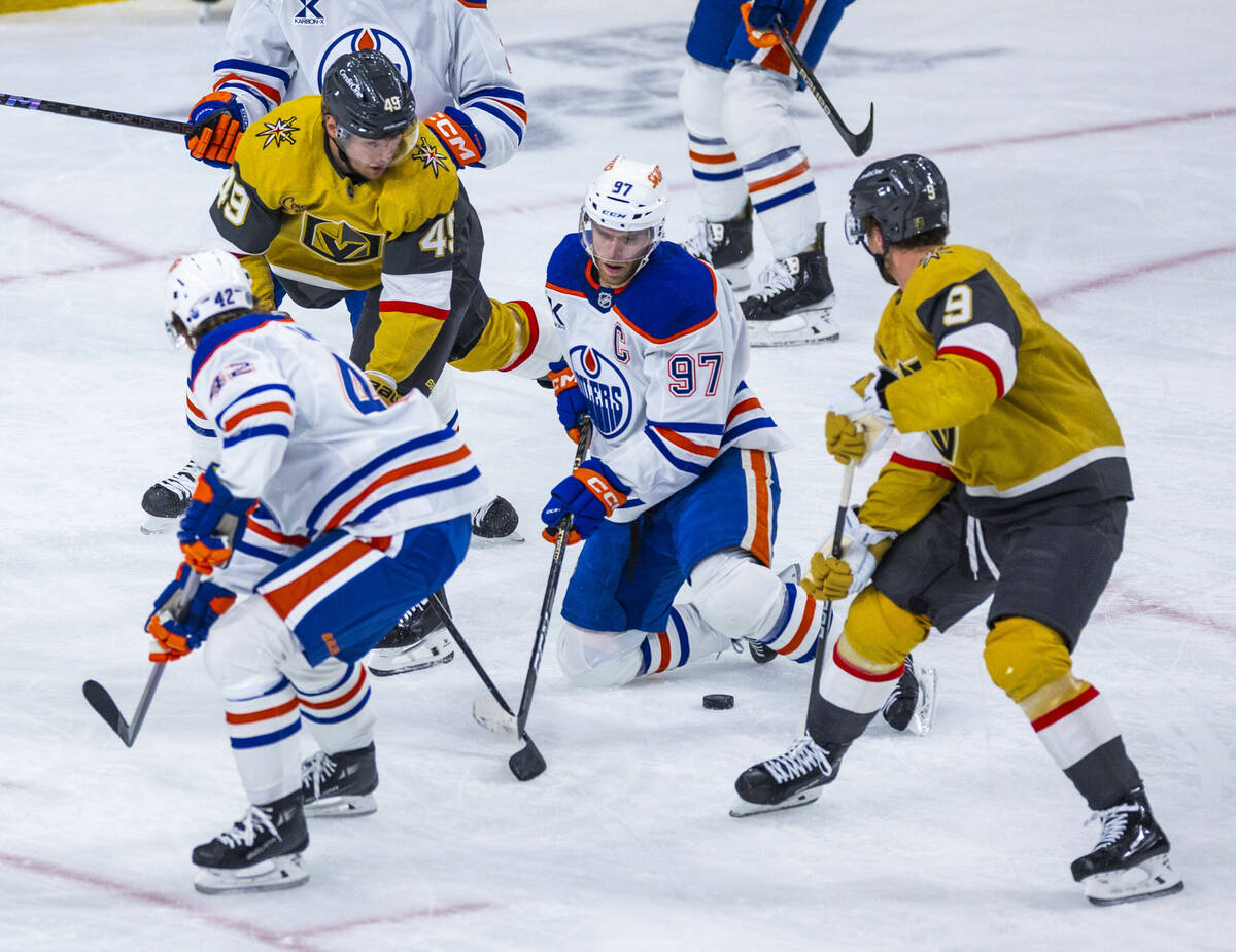 Golden Knights center Jack Eichel (9) looks to the puck after Edmonton Oilers center Connor McD ...