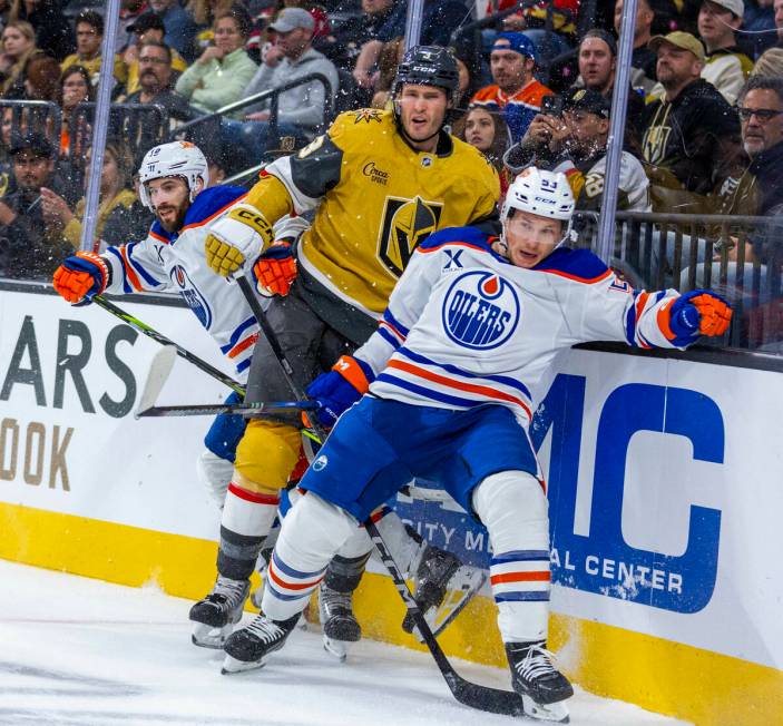 Golden Knights defenseman Brayden McNabb (3) is sandwiched between Edmonton Oilers center Jeff ...