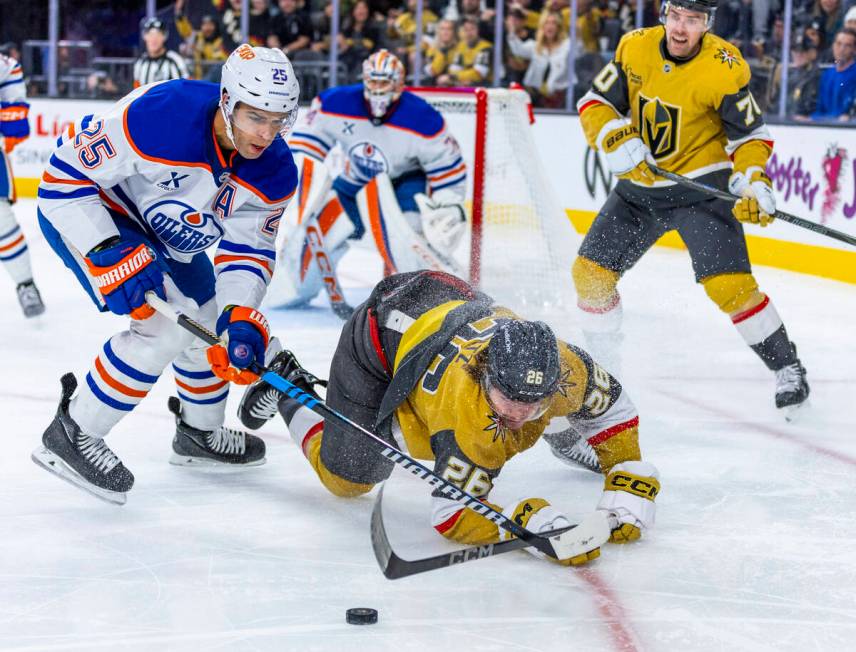 Golden Knights right wing Alexander Holtz (26) keeps control of the puck away from Edmonton Oil ...