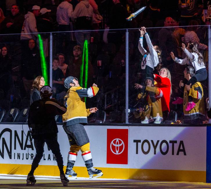 Golden Knights defenseman Brayden McNabb (3) tosses sword to a fan as a player of the game agai ...