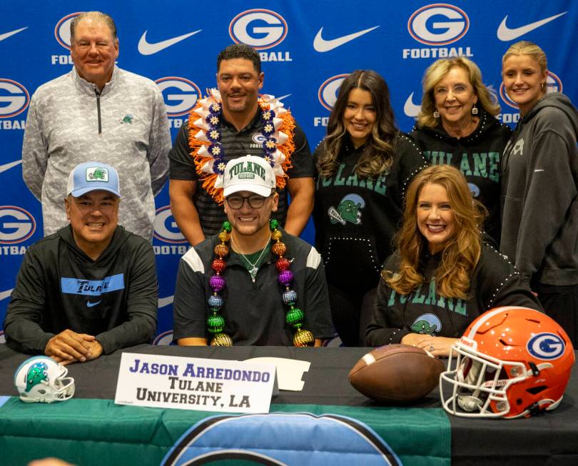 Bishop Gorman long snapper Jason Arredondo, center, signs a financial aid agreement with Tulane ...