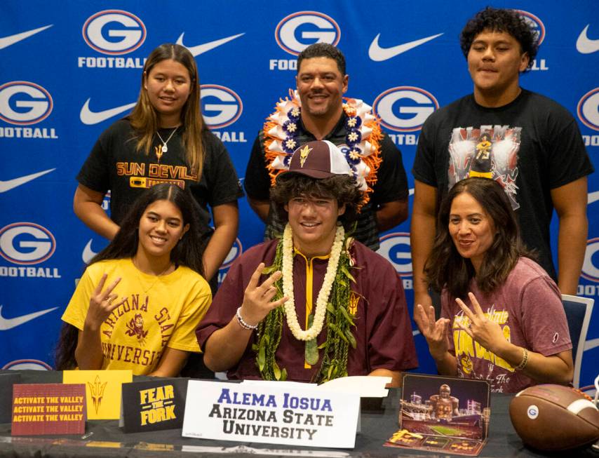 Bishop Gorman offensive tackle Alema Iosua, center, signs a financial aid agreement with Arizon ...