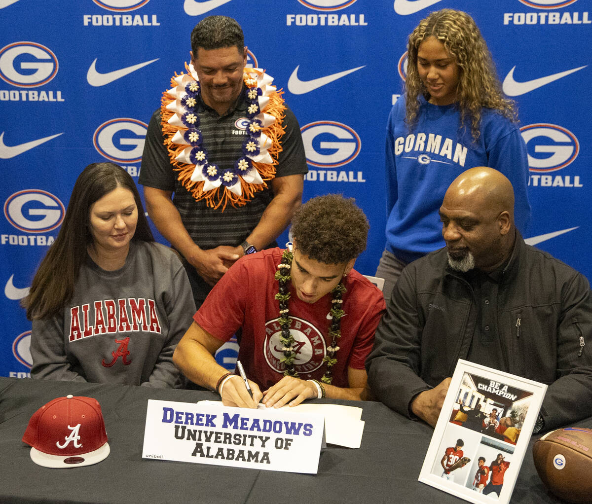 Bishop Gorman wide receiver Derek Meadows, center, signs a financial aid agreement with the Uni ...