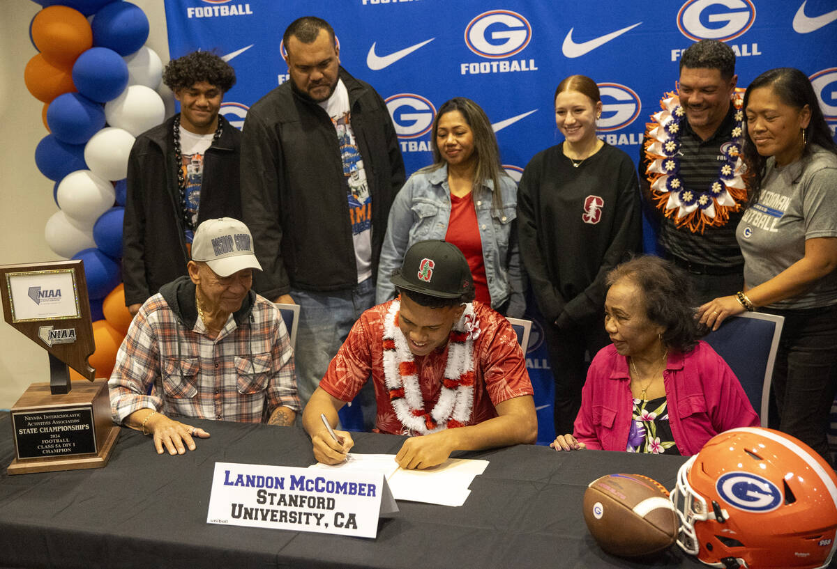 Bishop Gorman linebacker Landon McComber, center, signs a financial aid agreement with Stanford ...