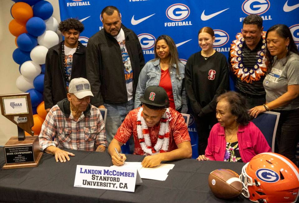 Bishop Gorman linebacker Landon McComber, center, signs a financial aid agreement with Stanford ...