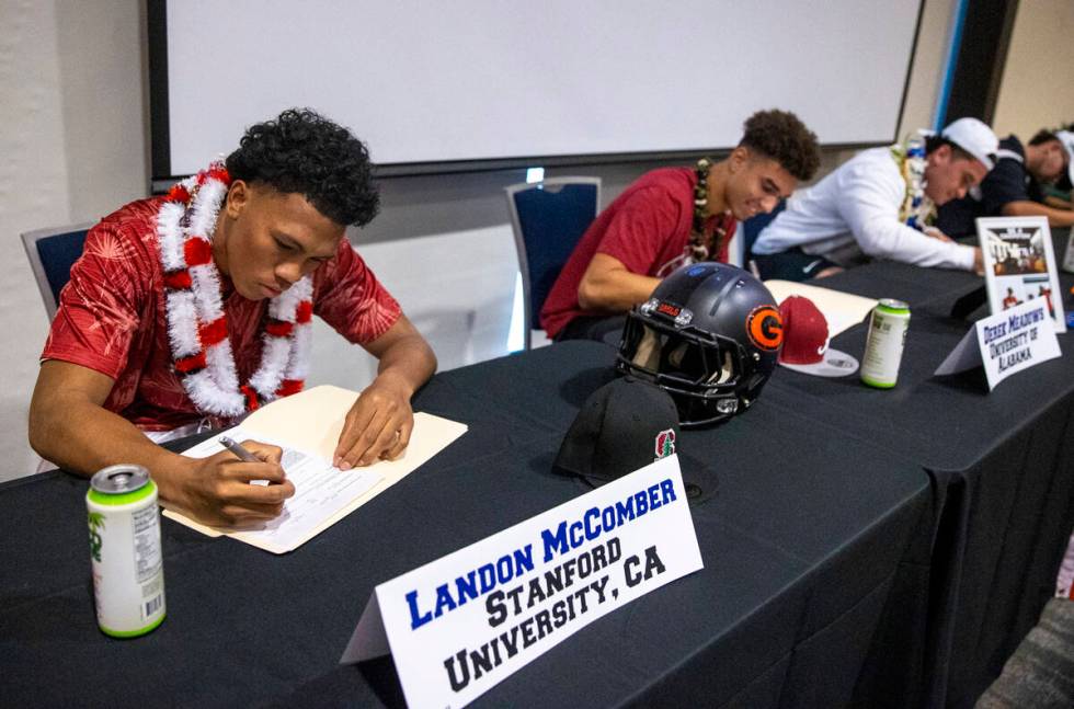 Bishop Gorman linebacker Landon McComber, left, signs a financial aid agreement with Stanford U ...