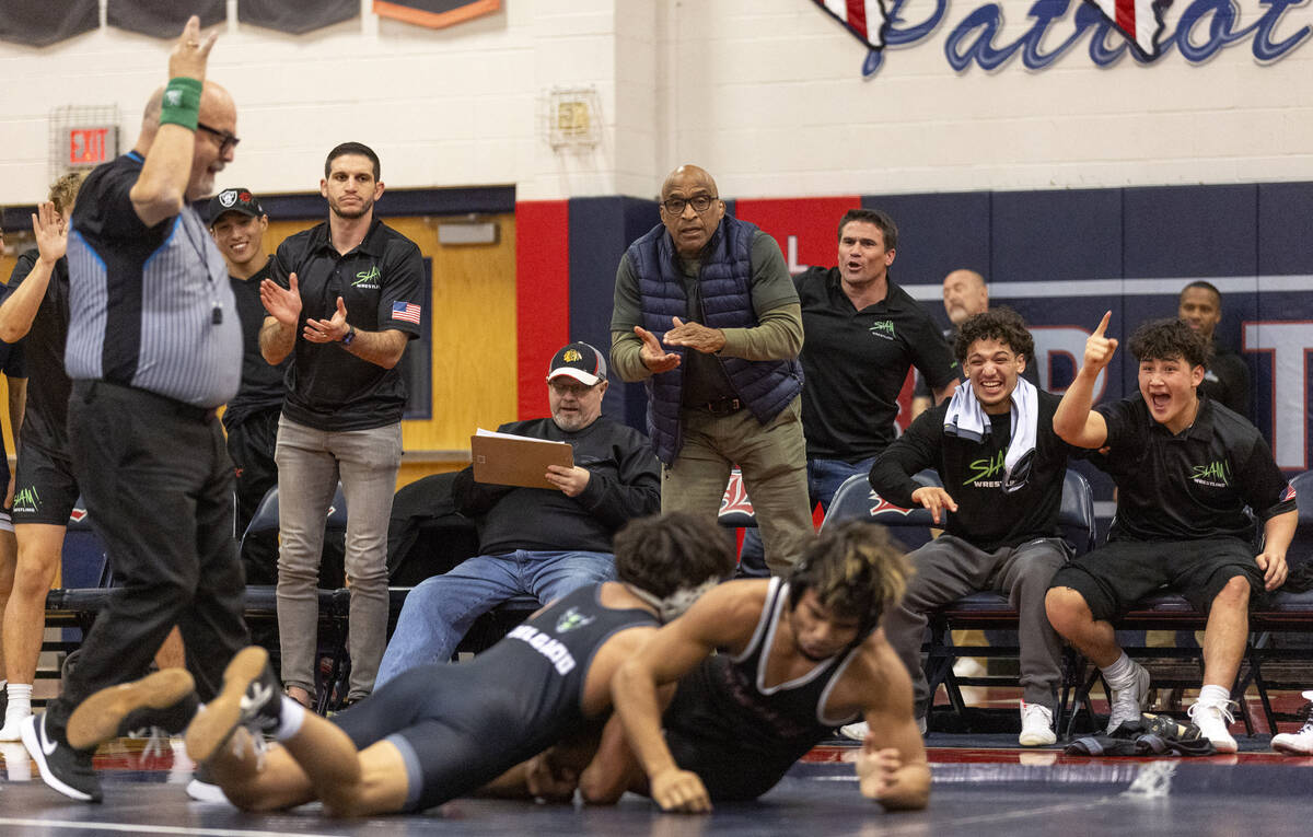 The SLAM Academy bench cheers after SLAM’s Anthony Delgado, left, gets on top of Liberty ...