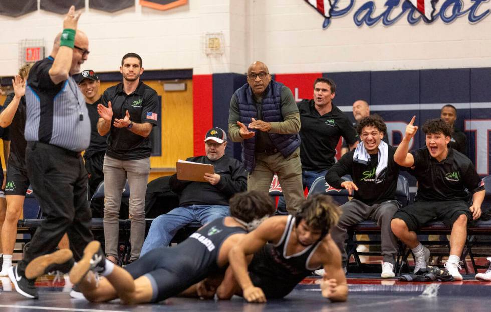 The SLAM Academy bench cheers after SLAM’s Anthony Delgado, left, gets on top of Liberty ...