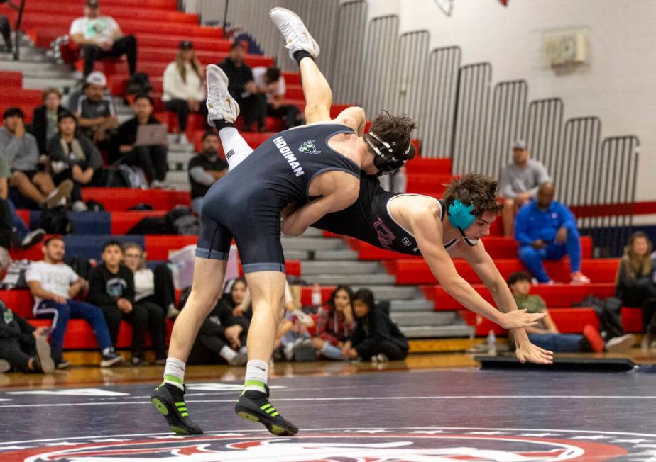 SLAM Academy’s Drake Hooiman, left, tosses Liberty’s Wyatte Nicholson, right, during the hi ...