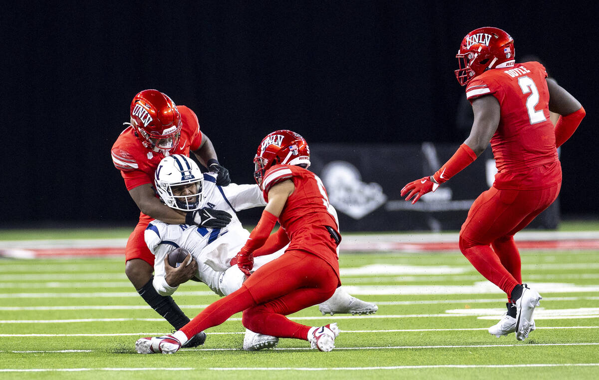 UNR quarterback Brendon Lewis (2) is tackled during the NCAA college football game against UNLV ...